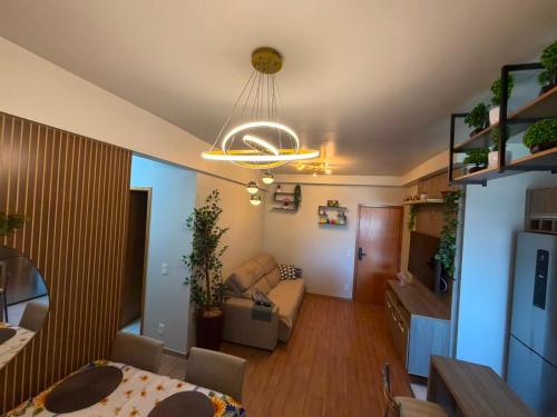 a living room with a couch and a dining room at Recanto Augusta in Londrina