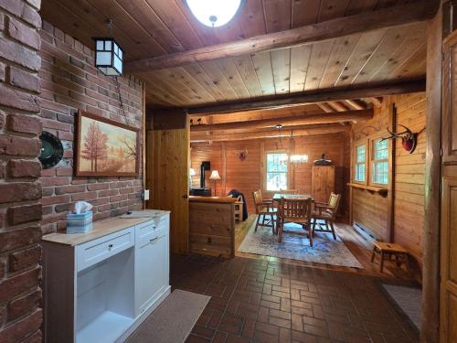 a kitchen with a table and a dining room at Highlands Hideaway - Secluded 4BR Forest Gem in Chemung