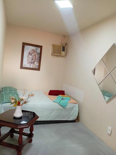 a small room with a bed and a table at VILA LEME Casa 11 in Rio de Janeiro