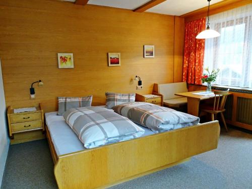 a bedroom with a bed and a desk and a table at Haus Christina in Trins
