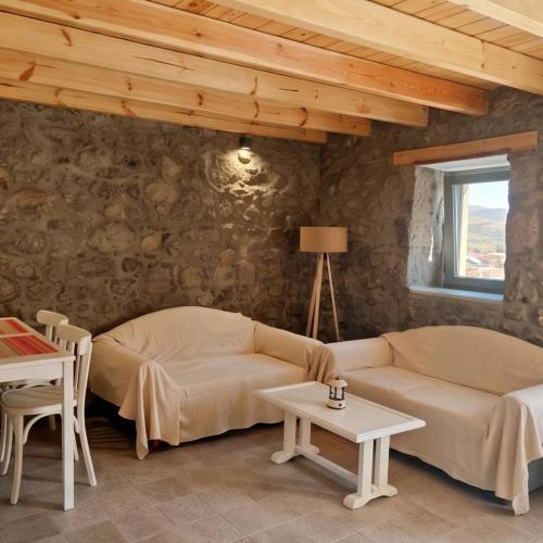 a living room with a couch and a table at Lithos Heritage in Líkhna