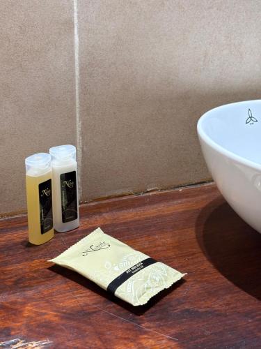 a bathroom with a sink and two bottles of soap at Nobile Hotel Solar del Acuario in Salto