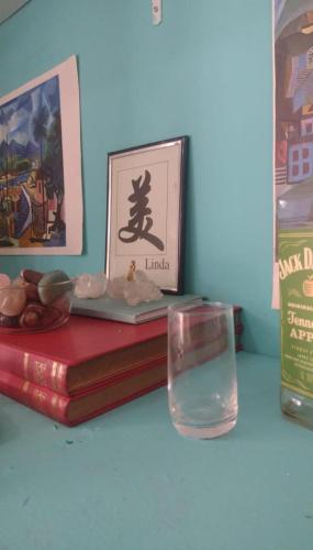 a table with two books and a glass of water at LEME Casa 11 in Rio de Janeiro