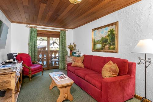 a living room with a red couch and a table at Christiania Lodge in Vail