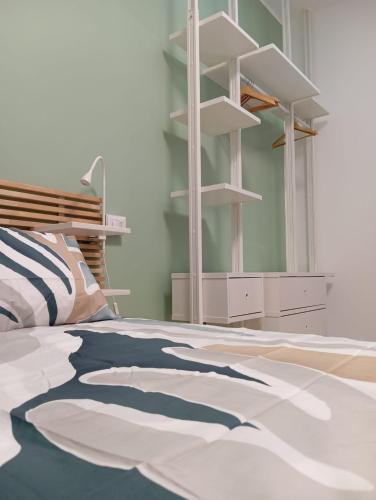 a bedroom with a bed and a mirror and shelves at La Rotonda in Mattinata
