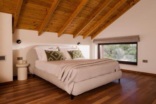 a bedroom with a bed and a large window at Jacomo Private Villa in Alykes