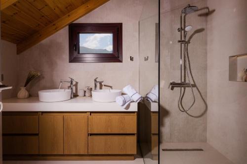 a bathroom with two sinks and a shower at Jacomo Private Villa in Alykes