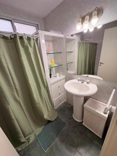a bathroom with a sink and a shower curtain at Rancho nuevo in Carhué