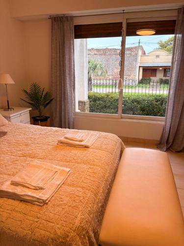 a bedroom with a bed and a large window at Rancho nuevo in Carhué