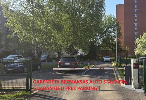 a street with a sign that reads gatetera berlinas auto shavers guaranteed at Barona apartement in Jelgava