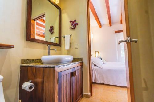 a bathroom with a sink and a mirror at Escondite condominios in Zihuatanejo