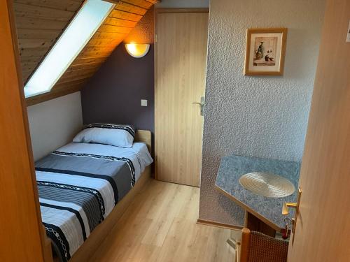 a small bedroom with a bed and a skylight at Il tempio del Gusto in Oelsnitz