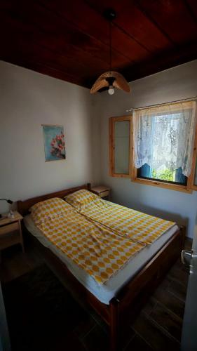 a bed in a bedroom with a window at BlePelagos house in Glossa