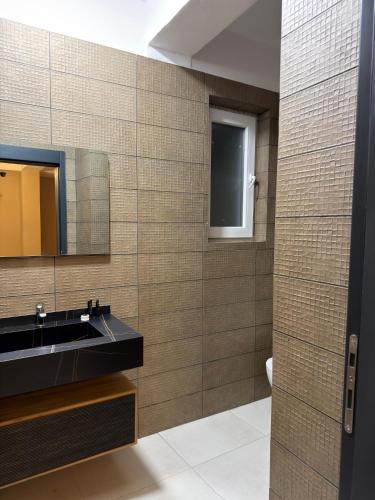 a bathroom with a sink and a mirror at Hotel Zurich in Golem