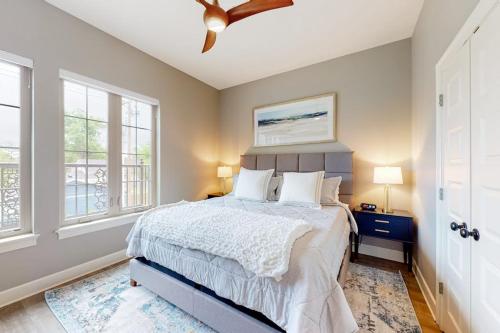 a bedroom with a bed and a ceiling fan at Bentonvilla in Bentonville