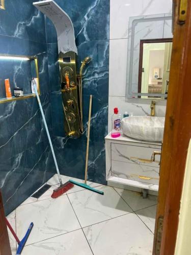 a bathroom with a mop on the floor and a sink at Oran Choupot boulevard principale in Oran