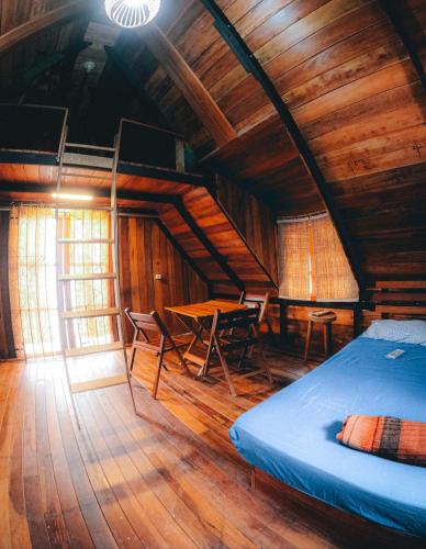 a bedroom with a bed and a wooden ceiling at CHALÉ ANGELIM in Belém