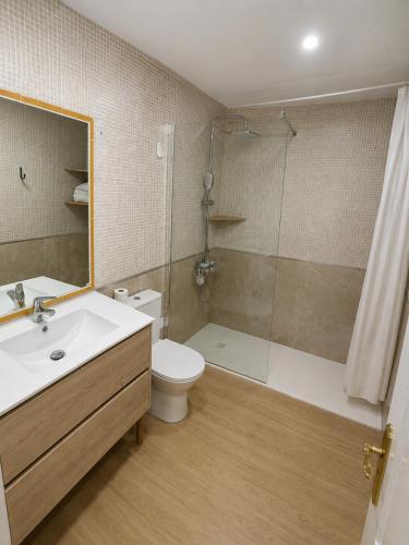 a bathroom with a sink and a toilet and a shower at Ático Cassinello Roquetas in Roquetas de Mar