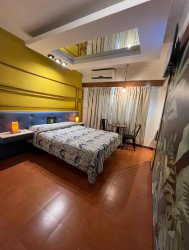 a bedroom with a bed and a table in it at Hotel Lido in General Rodríguez