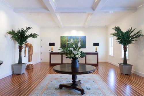 a living room with a table and two palm trees at Oceans Edge Key West in Key West