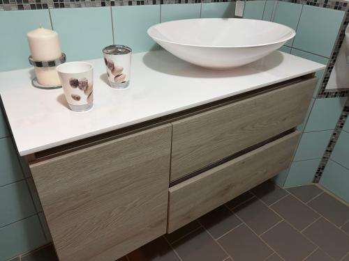 a bathroom with a large bowl sink on a counter at Angela's House in Barga