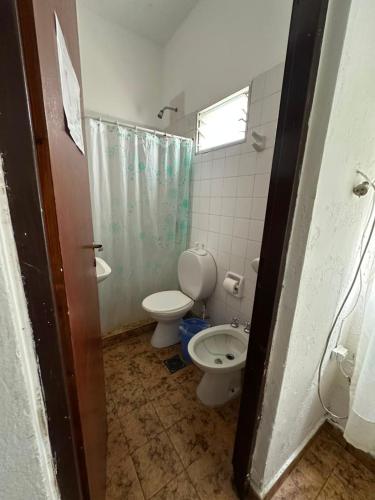 a bathroom with a toilet and a sink at Hotel San Jose in Federación
