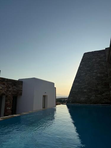 a swimming pool next to a building and a building at 2-bedroom villa Odysseus in Antiparos