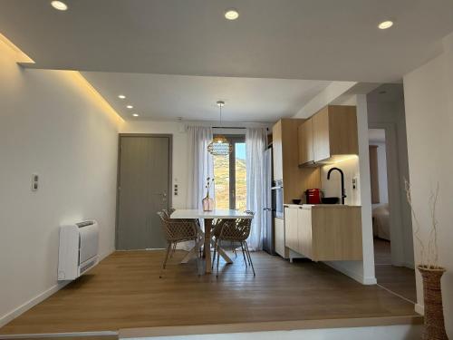 a kitchen and dining room with a table and chairs at 2-bedroom villa Odysseus in Antiparos