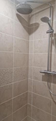a bathroom with a shower with a shower head at L'ecrin de Provence in Beaumes-de-Venise