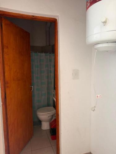 a bathroom with a toilet and a door open at Condominio Diamante in San Rafael