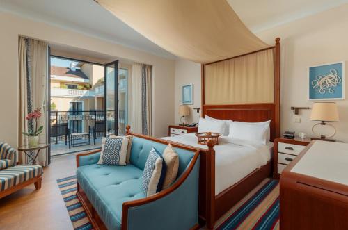 a hotel room with a bed and a couch at Regent Porto Montenegro in Tivat