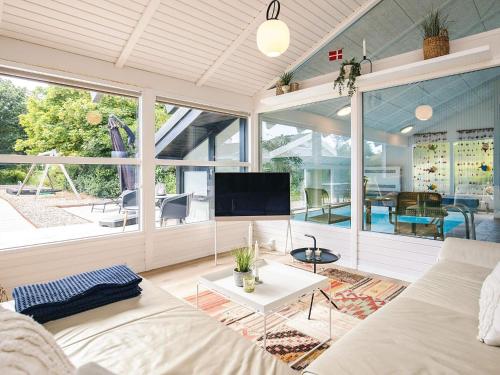 a living room with a couch and a tv at 5 star holiday home in Bindslev in Bindslev