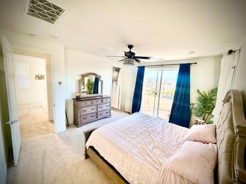 a bedroom with a bed and a dresser and a mirror at Valencia Resort in Santa Clarita