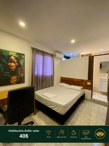 a bedroom with a bed and a chair in a room at Hotel Grand ilama in Cali