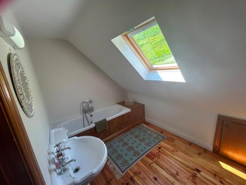a bathroom with a sink and a skylight at Griggins House in Cur