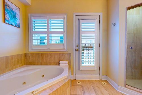 a large bathroom with a tub and a window at Private Rooftop Group Suite near Oriole Park - Eglinton Hotel in Toronto