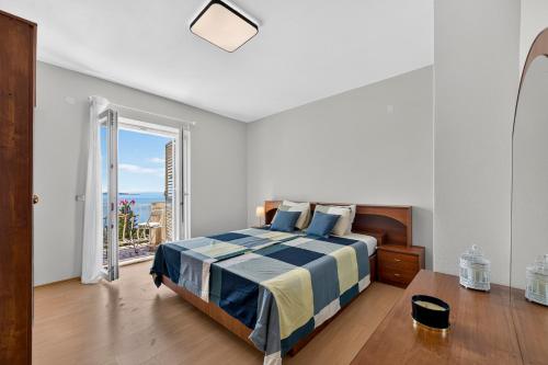 a bedroom with a bed with a view of the ocean at Room Blue View in Mlini