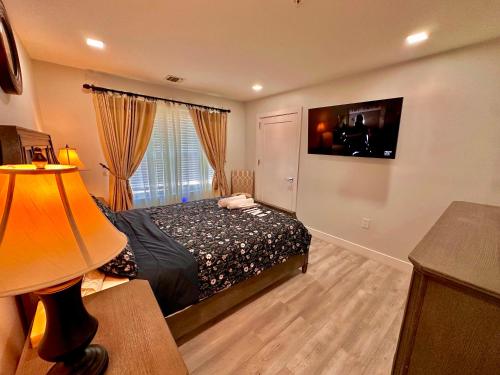 a bedroom with a bed and a large window at The Elegant Suite - 2BR with Great Amenities in Paterson