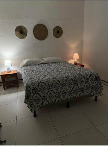 a bedroom with a bed with two tables and two lamps at Apartamento comodo en Rivas in Rivas