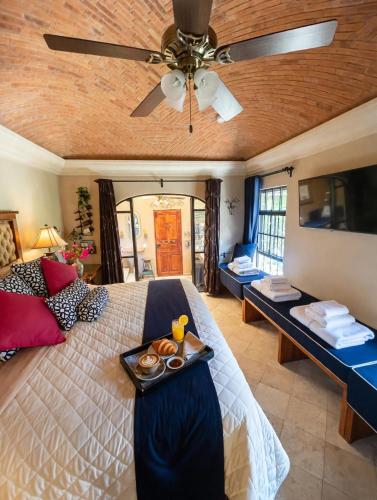 a bedroom with a bed with a tray of food on it at Casa Grande Luxury Boutique Hotel in San Miguel de Allende