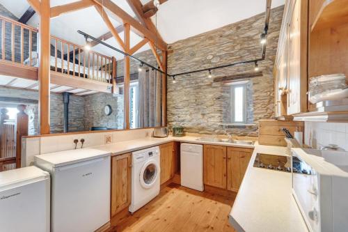 a large kitchen with a washer and dryer in it at 2 Bed in Ambleside oc-lr177 in Ambleside