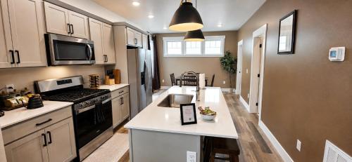 a kitchen with a sink and a stove at Walkable to Parks, Yellowstone River, Coffee Shop in Billings