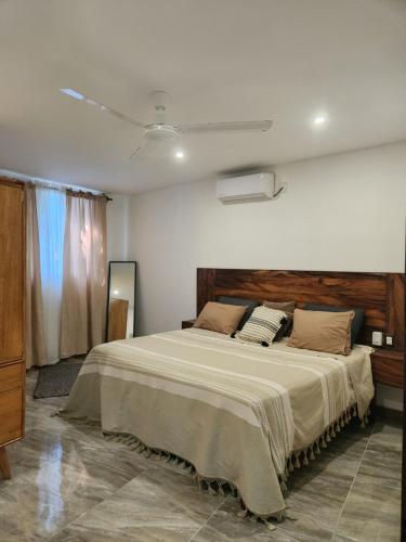 a bedroom with a large bed in a room at Habitaciones Huitzilin in Brisas de Zicatela