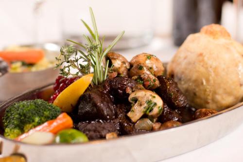 a bowl of food with vegetables and other foods at Flair-Hotel Zum Benediktiner in Schwarzach am Main