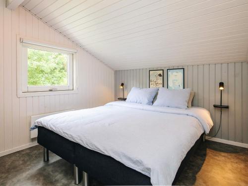 a large bed in a room with a window at 5 star holiday home in Bindslev in Bindslev