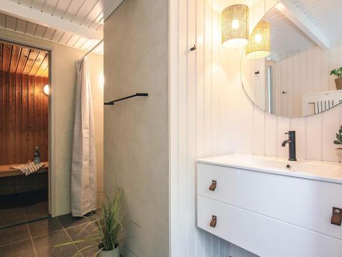 a bathroom with a sink and a mirror at 5 star holiday home in Bindslev in Bindslev