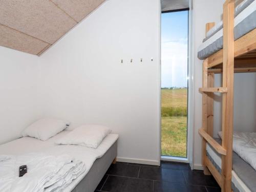 a bedroom with two bunk beds and a window at Luxury Retreat in Vorupor in Snedsted