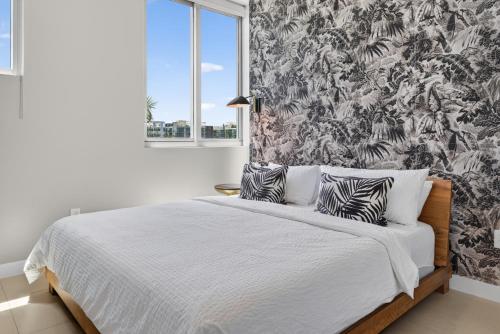a bedroom with a large bed with a large window at Ocean 2 Sky at Monte Carlo Miami Beach in Miami Beach