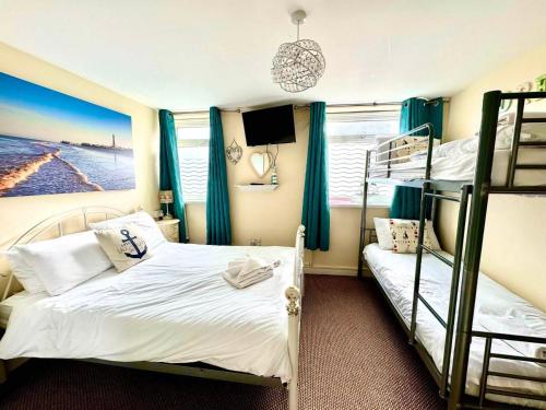 a bedroom with two bunk beds and a television at The Hurstmere in Blackpool