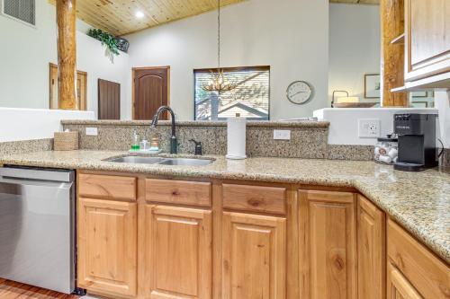 a kitchen with wooden cabinets and a sink at Hot Tub, Deck & Grill! Mtn Retreat in Show Low in Show Low